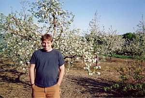 Andy Asack in home apple orchard during bloom